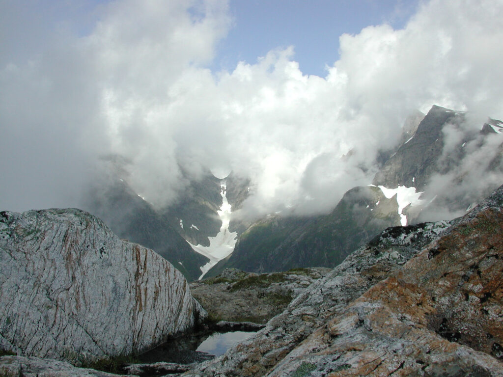 Ridge Top Pool and Cloud Covered Peaks