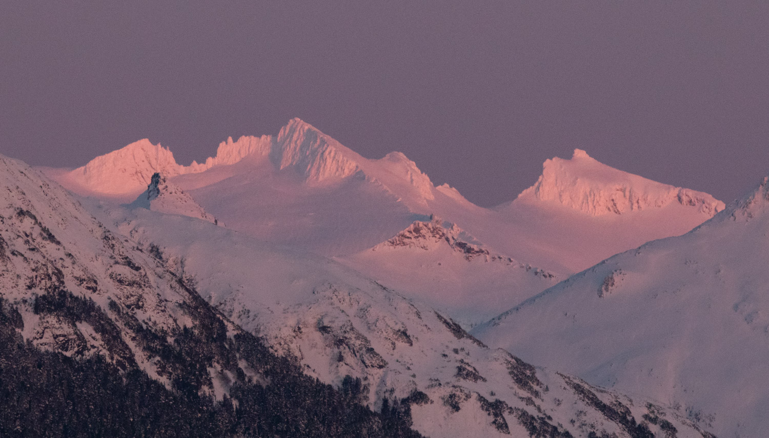 Alpenglow on Snow-covered Mountains