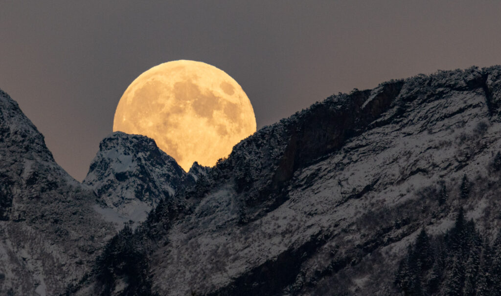 Full Moon Cresting Mountain Ridges