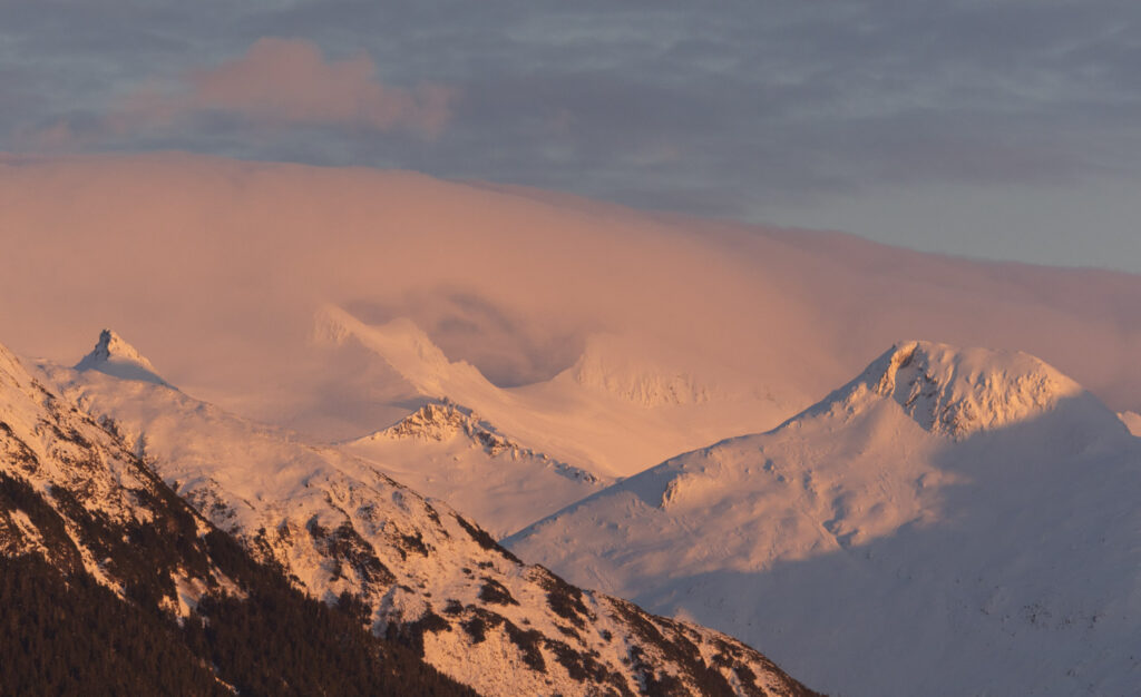 Alpenglow on Clouds and Mountains