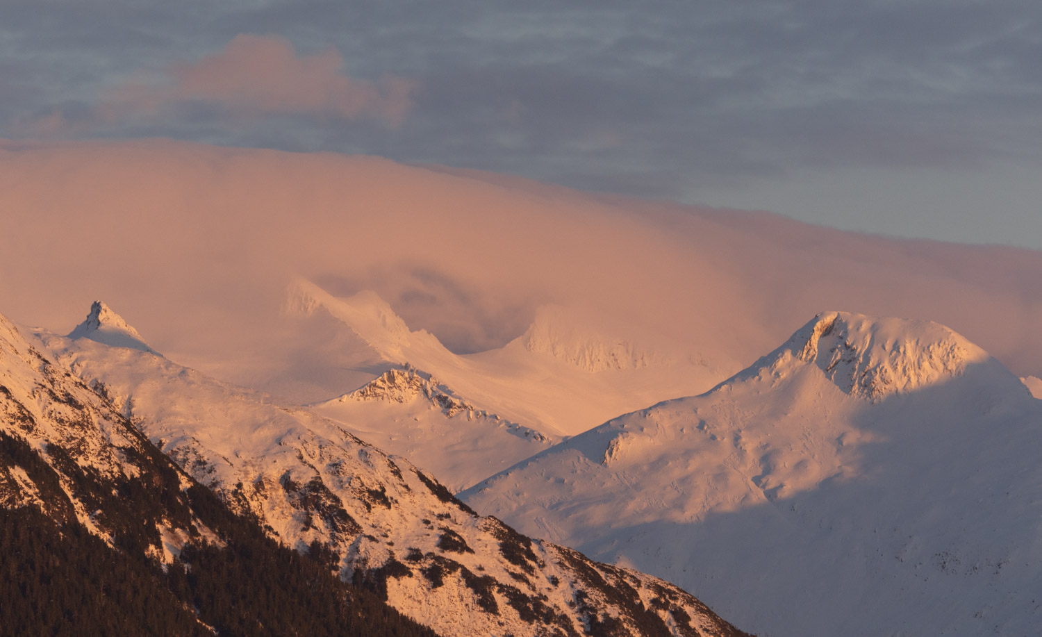 Alpenglow on Clouds and Mountains