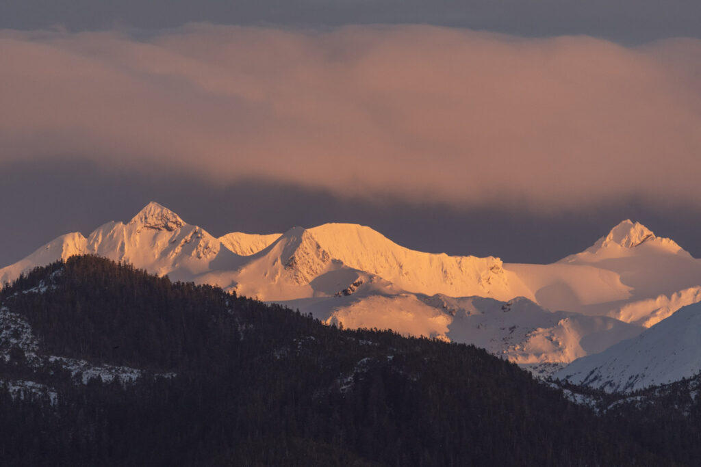 Alpenglow on Clouds and Mountains