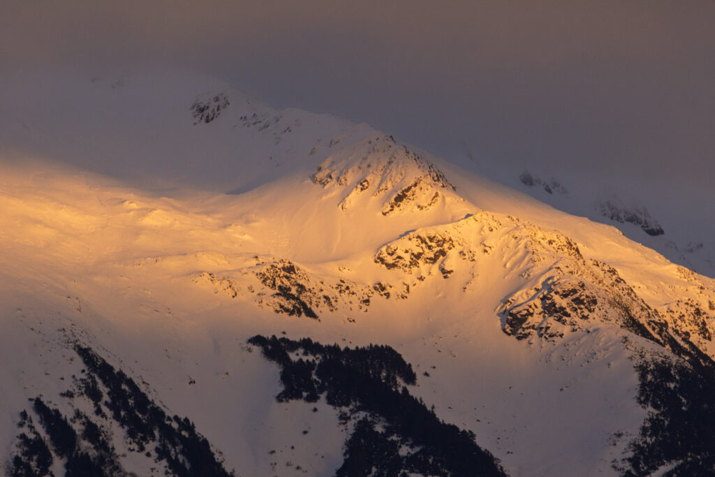 Wedge of Sunlight on Snow-covered Mountain Slopes